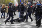 FILE – Riot police officers detain a youth during a demonstration Thursday, April 6, 2023 in Paris. (AP Photo/Michel Euler, File)