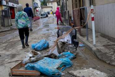 People walk in a flooded street of Campi di Bisenzio, in the central Italian Tuscany region, Friday, Nov. 3, 2023. Record-breaking rain provoked floods in a vast swath of Tuscany as storm Ciaran pushed into Italy overnight Friday, trapping people in their homes, inundating hospitals and overturning cars. At least three people were killed, and four were missing. (AP Photo/Gregorio Borgia) Associated Press / LaPresse Only italy and Spain