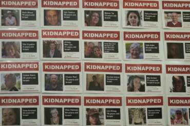 Photographs of hostages taken after the Oct. 7 assault by Hamas militants, are displayed at a news conference at the Israel Embassy in London, Monday, Nov. 20, 2023. More than 200 Israelis and foreigners were taken hostage on Oct. 7 after Hamas militants infiltrated Israel. (AP Photo/Kin Cheung)