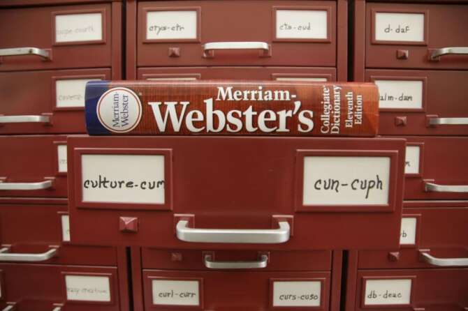 FILE – A Merriam-Webster dictionary sits atop their citation files at the dictionary publisher’s offices on Dec. 9, 2014, in Springfield, Mass. Merriam-Webster’s word of the year for 2023 is “authentic.” (AP Photo/Stephan Savoia, File)