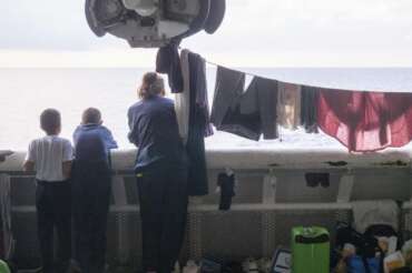 Some of the 258 people, including Syrians, Egyptians, Bangladeshi, and South-Sudanese, saved from the sea in two different rescue operations on Friday are taken to safety on board of the Doctors Without Borders’ search and rescue ship Geo Barents sailing in the Mediterranean Sea, Sunday, Oct. 8, 2023. (AP Photo/Paolo Santalucia)
