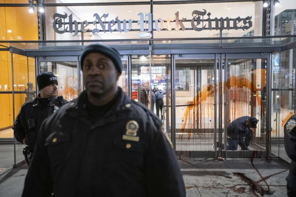 New York Police Officers stand guard in front of the New York Times building entrance after being vandalized with red tint by Pro-Palestinian demonstrators as they march calling for a cease fire in Gaza, Friday, Nov. 10, 2023, in New York. (AP Photo/Eduardo Munoz Alvarez)