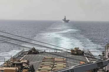 In this image provided by the U.S. Navy, the amphibious dock landing ship USS Carter Hall and amphibious assault ship USS Bataan transit the Bab al-Mandeb strait on Aug. 9, 2023. The top commander of U.S. naval forces in the Middle East says Yemen’s Houthi rebels are showing no signs of ending their “reckless” attacks on commercial ships in the Red Sea. But Vice Adm. Brad Cooper said in an Associated Press interview on Saturday that more nations are joining the international maritime mission to protect vessels in the vital waterway and trade traffic is beginning to pick up. (Mass Communications Spc. 2nd Class Moises Sandoval/U.S. Navy via AP)