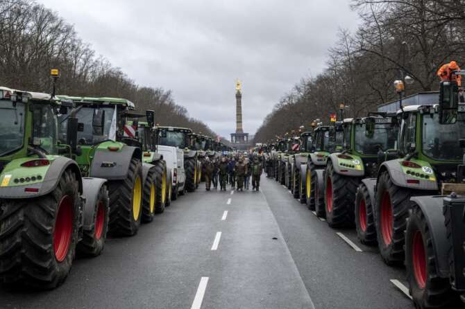 Farmers placed their tractors at the government district in Berlin, Germany, Monday, Jan 15, 2024. Farmers have driven thousands of tractors into Berlin in the climax of a week of demonstrations against a plan to scrap tax breaks on the diesel they use, a protest that has tapped into wider discontent with Germany’s government. (AP Photo/Ebrahim Noroozi)