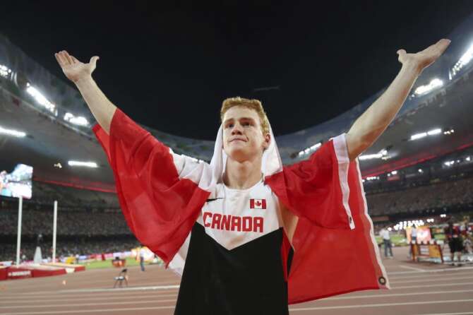FILE – Canada’s Shawn Barber celebrates after winning the gold medal in the men’s pole vault final at the World Athletics Championships at the Bird’s Nest stadium in Beijing, Monday, Aug. 24, 2015. Barber has died from medical complications. He was 29. Barber died Wednesday, Jan. 17, 2024, at home in Kingwood, Texas, his agent, Paul Doyle, confirmed to The Associated Press.(Christian Charisius/dpa via AP, File)