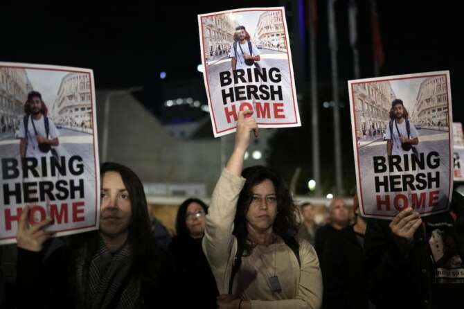 People hold signs showing a picture of a hostage during a demonstration calling for the release of the hostages taken by Hamas militants to Gaza during the Oct. 7th attack, during a demonstration in Tel Aviv, Israel, Saturday Jan. 20, 2024. (AP Photo/Leo Correa)