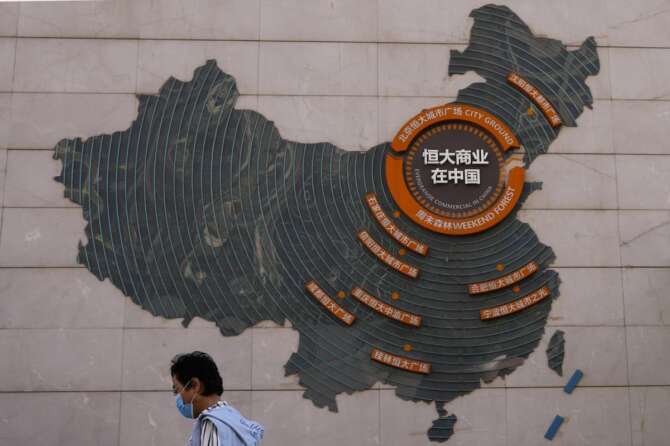 FILE- A woman walks past a map showing Evergrande development projects in China, at an Evergrande city plaza in Beijing on Sept. 21, 2021. Chinese property developer China Evergrande Group on Monday, Jan. 29, 2024 was ordered to liquidate by a Hong Kong court, after the firm was unable to reach a restructuring deal with creditors. (AP Photo/Andy Wong, File) Associated Press/LaPresse Only Italy and Spain