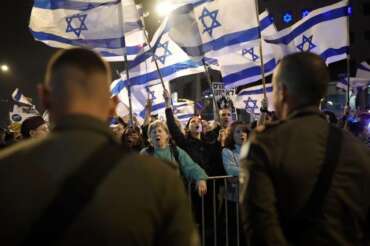 People protest against Israeli Prime Minister Benjamin Netanyahu’s government in Tel Aviv, Israel, Saturday, March 2, 2024. (AP Photo/Leo Correa)