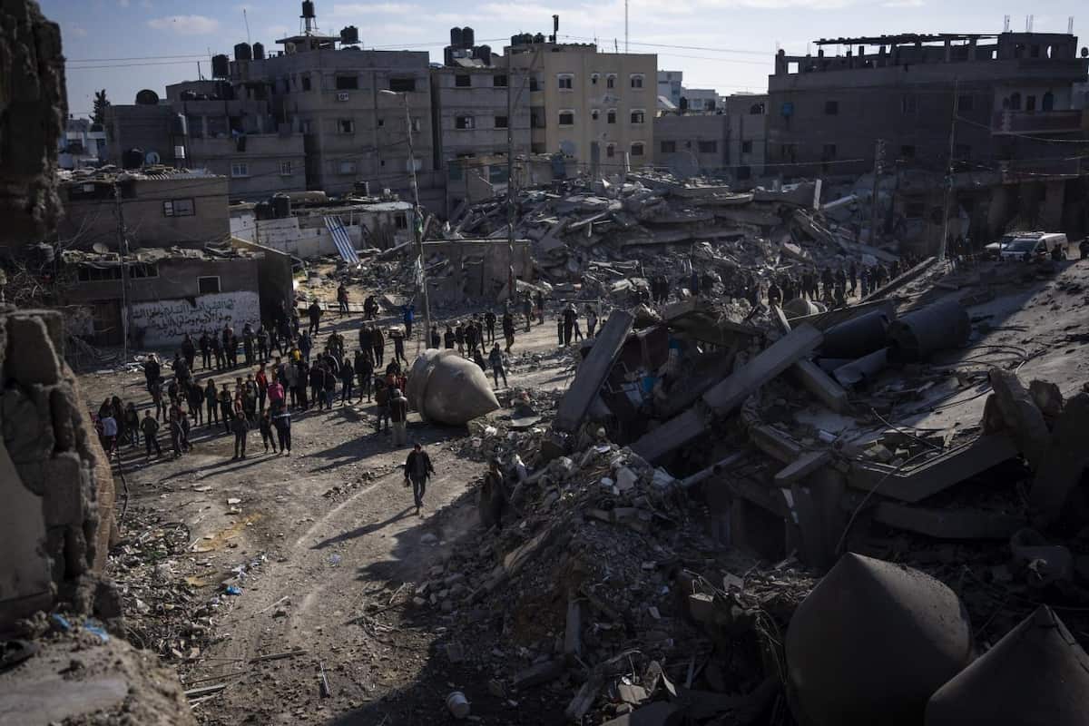 Palestinians look at the destruction after an Israeli strike on residential buildings and a mosque in Rafah, Gaza Strip, Thursday, Feb. 22, 2024. (AP Photo/Fatima Shbair)