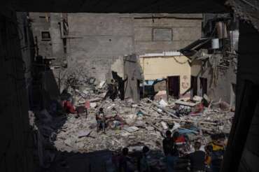 Members of the Abu Draz family inspect their house after it was hit by an Israeli airstrike in Rafah, southern Gaza Strip, Thursday, April 4, 2024. (AP Photo/Fatima Shbair)