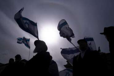 People take part in a demonstration of solidarity with Israel in Berlin, Sunday, April 14, 2024 following the Iranian attacks on Israel overnight. Israel praised the success of its defenses in the face of an unprecedented attack by Iran involving hundreds of drones, ballistic missiles and cruise missiles. (AP Photo/Markus Schreiber)