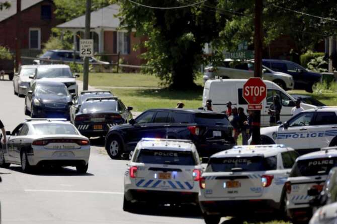 Multiple law enforcement vehicles respond in the neighborhood where several officers on a task force trying to serve a warrant were shot in Charlotte, N.C., Monday, April 29, 2024. (Khadejeh Nikouyeh/The Charlotte Observer via AP)