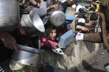 FILE – Palestinians line up for free food during the ongoing Israeli air and ground offensive on the Gaza Strip in Rafah, Jan. 9, 2024. A top U.N. official said Friday, May 3, 2024, that hard-hit northern Gaza was now in “full-blown famine” after more than six months of war between Israel and Hamas and severe Israeli restrictions on food deliveries to the Palestinian territory. (AP Photo/Hatem Ali, File)