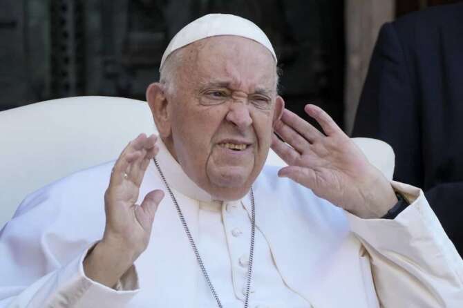 Pope Francis listens to the crowd gathered outside the Basilica of St. Zeno at the end of a meeting with priests and consecrated persons, during a one-day pastoral visit to the northern Italian town of Verona, Saturday, May 18, 2024. (AP Photo/Gregorio Borgia)