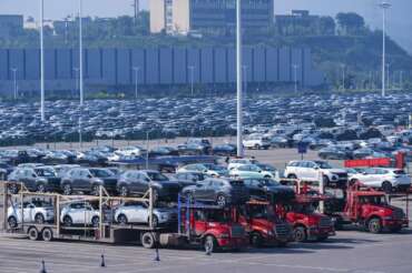 New passenger cars are prepared for transportation at a logistics center of Changan Auto in southwestern China’s Chongqing Municipality on Sunday, Oct. 15, 2023. Sales of passenger cars rose 10.2% in October over a year earlier, an industry association said Wednesday, Nov. 8, as makers ramped up promotions and customers opted for electric and hybrid vehicles. (Chinatopix Via AP)