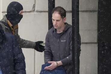 FILE – Wall Street Journal reporter Evan Gershkovich is escorted from a court hearing in Moscow, Russia, on Friday, Jan. 26, 2024. Gershkovich was detained on espionage charges in March 2023 – an accusation that he, his employer and the U.S. government denies. (AP Photo/Alexander Zemlianichenko, File)