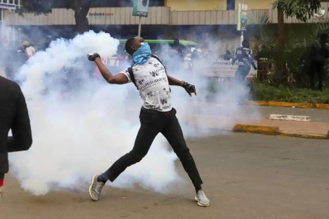 A protesters throws back a teargas canister at police officers during a protest over proposed tax hikes in a finance bill that is due to be tabled in parliament in Nairobi, Kenya, Thursday, June 20, 2024. (AP Photo/ Andrew Kasuku) Associated press / LaPresse Only italy and Spain