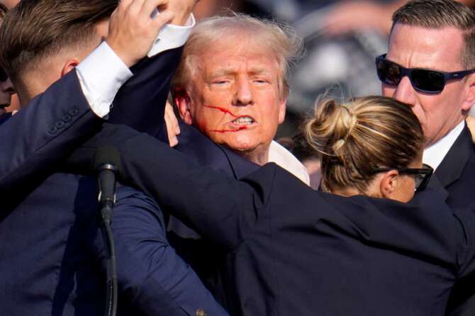 Republican presidential candidate former President Donald Trump is helped off the stage by U.S. Secret Service agents at a campaign event in Butler, Pa., on Saturday, July 13, 2024. (AP Photo/Gene J. Puskar) Associated Press / LaPresse Only italy and Spain