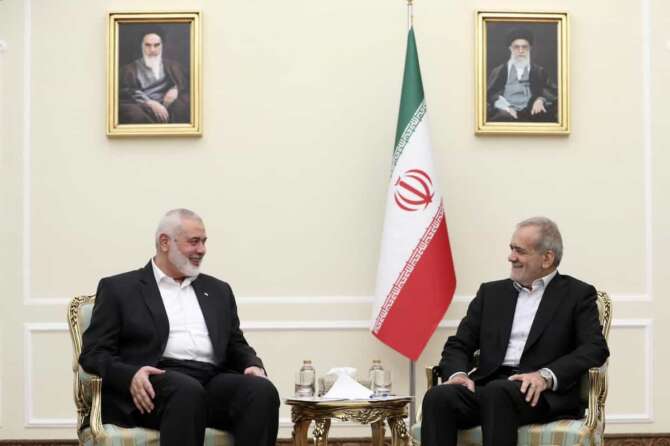 In this photo released by the Iranian Presidency Office, President Masoud Pezeshkian, right, meets Hamas chief Ismail Haniyeh, at the President’s office in Tehran, Iran, Tuesday, July 30, 2024. (Iranian Presidency Office via AP)