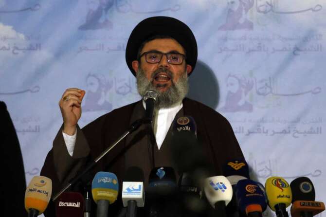 Senior Hezbollah leader Hashem Safieddine speaks during a conference for Saudi opposition in the southern Beirut suburb of Dahiyeh, Lebanon, Wednesday, Jan. 12, 2022. Lebanon’s powerful Hezbollah group hosted a conference for Saudi opposition figures in its stronghold south of Beirut Wednesday in a defiant gesture certain to anger the oil-rich kingdom. (AP Photo/Bilal Hussein)