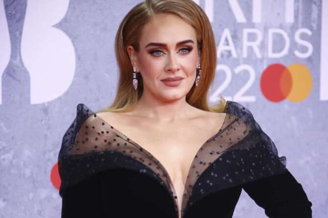 FILE – Adele appears at the Brit Awards in London on Feb. 8, 2022. Adele paid homage to the many women – including her mother, grandmother and aunts – who helped shape her world and personality as she accepted the Sherry Lansing leadership award at The Hollywood Reporter’s Women in Entertainment breakfast gala Thursday, Dec. 7, 2023. (Photo by Joel C Ryan/Invision/AP, File)