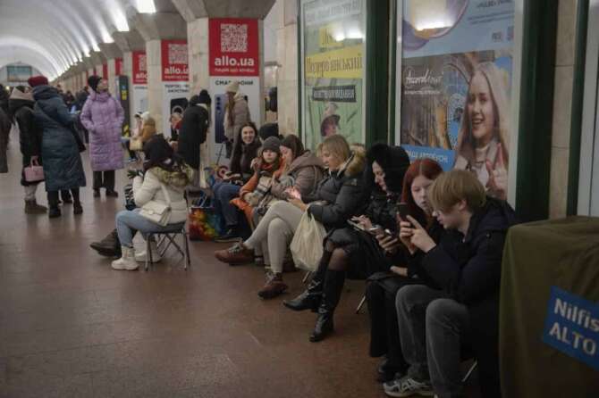 People hide in an underground metro station during Russia’s missile attack alert on Christmas Eve in Kyiv, Ukraine, Tuesday, Dec. 24, 2024. (AP Photo/Efrem Lukatsky)