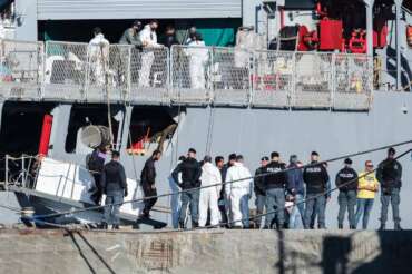Migrants disembark from the Italian navy ship Libra at the port of Shengjin, northwestern Albania, Friday, Nov. 8, 2024, as a second group of eight migrants intercepted in international waters is processed in a reception facility despite the failure with the first group in October. (AP Photo/Vlasov Sulaj)