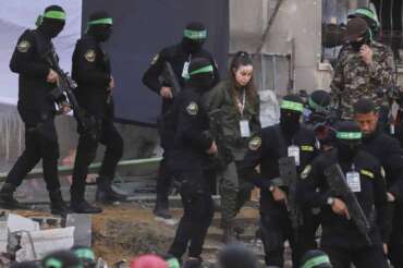 Israeli soldier Agam Berger walks next to masked Islamic Jihad militants as she is handed over to the Red Cross at the Jabalya refugee camp in Gaza City, Thursday Jan. 30, 2025.(AP Photo/Mohammed Hajjar) Associated Press/LaPresse