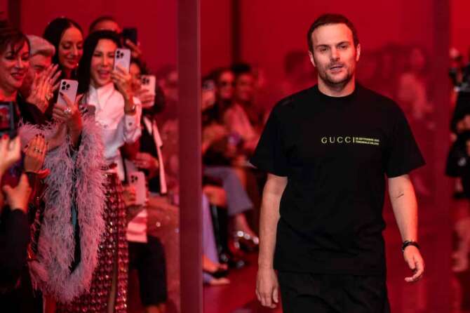 Sabato De Sarno, creative director of Gucci, accepts applause after the Gucci Spring Summer 2025 collection, that was presented in Milan, Italy, Friday, Sept. 20, 2024. (AP Photo/Luca Bruno).