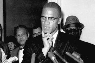 FILE – Malcolm X speaks to reporters in Washington, D.C., May 16, 1963. (AP Photo, File)