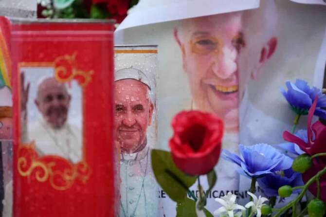 Raindrops are are seen on candles adorned with pictures of Pope Francis outside the Agostino Gemelli Polyclinic where the Pontiff is hospitalized in Rome, Monday, Feb. 24, 2025. (AP Photo/Gregorio Borgia) Associated Press / LaPresse Only italy and spain