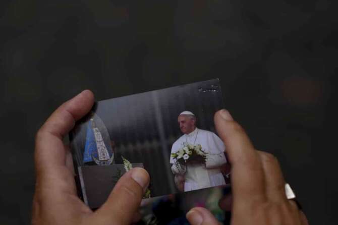 A woman holds a photo of Pope Francis during a Mass to pray for his health at Constitucion square in Buenos Aires, Argentina, Monday, Feb. 24, 2025. (AP Photo/Natacha Pisarenko) Associated Press/LaPresse