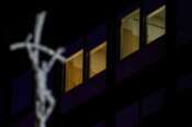 A crucifix is seen in front of the windows of the ward where Pope Francis is hospitalized at the Agostino Gemelli Polyclinic, in Rome, Italy, Sunday, March 2, 2025. (AP Photo/Andrew Medichini)