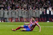 Atletico Madrid’s Julian Alvarez falls to the ground after taking a penalty kick during a shootout at the end of the Champions League round of 16, second leg, soccer match between Atletico Madrid and Real Madrid at the Metropolitano stadium in Madrid, Spain, Wednesday, March 12, 2025. (AP Photo/Manu Fernandez)