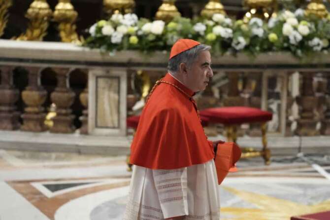 Cardinal Angelo Becciu arrives for the start of a public concistory in St. Peter’s Basilica at The Vatican, Saturday, Dec. 7, 2024, where Pope Francis will elevate 21 new cardinals. (AP Photo/Gregorio Borgia)