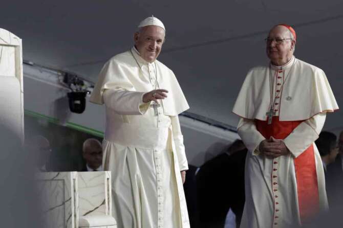 FILE – Pope Francis, left, is flanked by Cardinal Kevin Farrell during a vigil at Campo San Juan Pablo II in Panama City, Jan. 26, 2019. (AP Photo/Alessandra Tarantino, File ) Associated Press/LaPresse