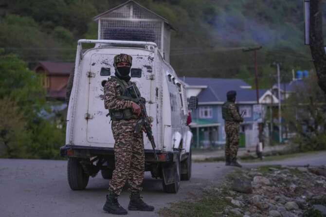 Indian security officers stand guard near Pahalgam in south Kashmir after assailants indiscriminately opened fired at tourists visiting Pahalgam, Indian controlled Kashmir, Tuesday, April 22, 2025.(AP Photo/Dar Yasin)