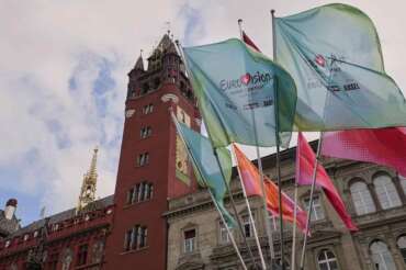 Eurovision flags wave in front of the 500-year-old Basel Town Hall in the city center ahead of the first semi-final of the 69th Eurovision Song Contest, in Basel, Switzerland, Tuesday, May 13, 2025. (AP Photo/Martin Meissner) Associated Press/LaPresse