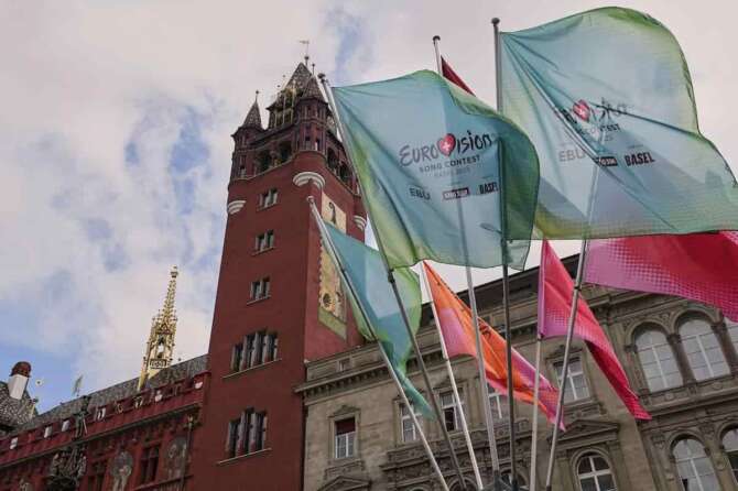 Eurovision flags wave in front of the 500-year-old Basel Town Hall in the city center ahead of the first semi-final of the 69th Eurovision Song Contest, in Basel, Switzerland, Tuesday, May 13, 2025. (AP Photo/Martin Meissner) Associated Press/LaPresse
