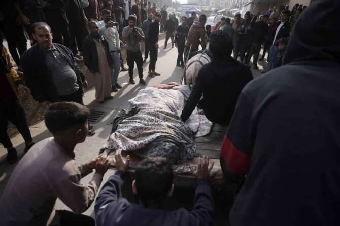 Palestinians killed in the Israeli bombardment of the Gaza Strip are brought on a donkey cart to the hospital in Khan Younis, Gaza Strip, on Wednesday, Dec. 27, 2023. (AP Photo/Mohammed Dahman)