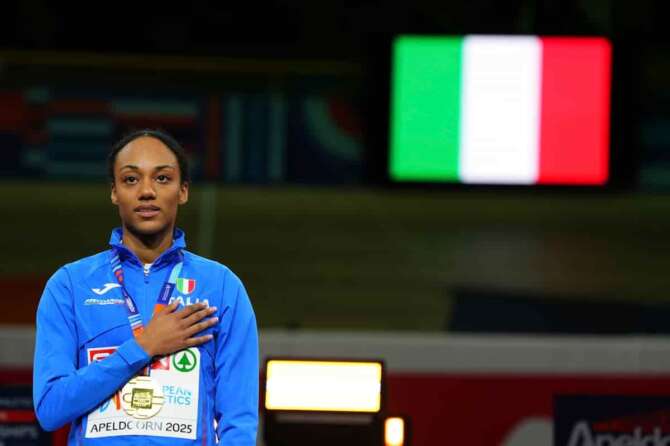 Gold medalist Italy’s Larissa Iapichino celebrates on the podium for the Women’s Long Jump during the European Athletics Indoor Championships in Apeldoorn, Netherlands, Sunday, March 9, 2025. (AP Photo/Peter Dejong)
