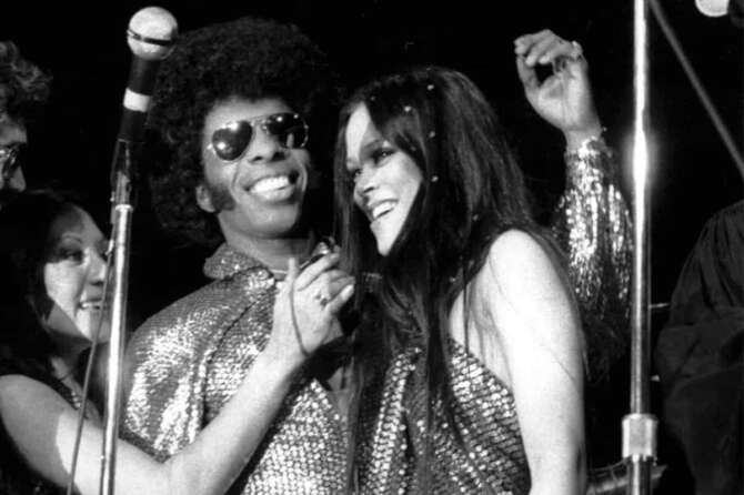 FILE – Sylvester “Sly” Stewart and his bride Kathy Silva, right, are congratulated during their wedding ceremony at a rock concert by Sly and the Family Stone at New York’s Madison Square Garden on June 6, 1974. (AP Photo/Richard Drew, File)