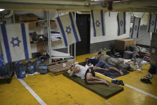 People rest and as they take shelter in an underground parking garage as a precaution against possible Iranian missile attacks, in Tel Aviv, Israel, Tuesday, June 24, 2025. (AP Photo/Ohad Zwigenberg) Associated Press/LaPresse