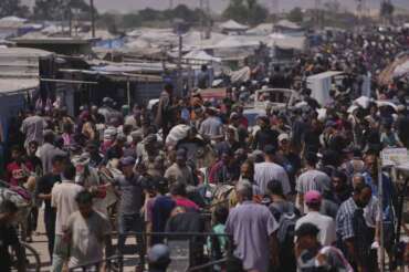 Palestinians carry bags containing food and humanitarian aid packages delivered by the Gaza Humanitarian Foundation, a U.S.-backed organization, in Rafah, southern Gaza Strip, Wednesday, June 25, 2025. (AP Photo/Abdel Kareem Hana)