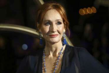 FILE – J.K. Rowling poses for photographers upon her arrival at the premiere of the film ‘Fantastic Beasts: The Crimes of Grindelwald’, in London, Nov. 13, 2018. Police say J.K. Rowling didn’t break the law with tweets criticizing Scotland’s new hate speech law and referring to transgender women as men. (Photo by Joel C Ryan/Invision/AP, File)