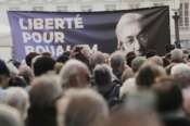 A placard reading ”Freedom for Boualem Sansal” is seen during a gathering in support of detained Franco-Algerian writer Boualem Sansal, in Paris, Tuesday, March 25, 2025. (AP Photo/Thibault Camus)