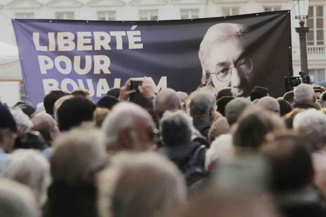A placard reading ”Freedom for Boualem Sansal” is seen during a gathering in support of detained Franco-Algerian writer Boualem Sansal, in Paris, Tuesday, March 25, 2025. (AP Photo/Thibault Camus)