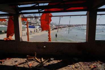 A Palestinian stands on the beach outside a cafe that was damaged in an Israeli strike, Gaza City, Monday, June 30, 2025. (AP Photo/Jehad Alshrafi)