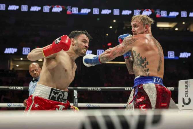 FILE – Julio Cesar Chavez Jr., left, throws a punch at Jake Paul during their cruiserweight boxing match, in Anaheim, Calif., June 28, 2025. (AP Photo/Etienne Laurent, File)