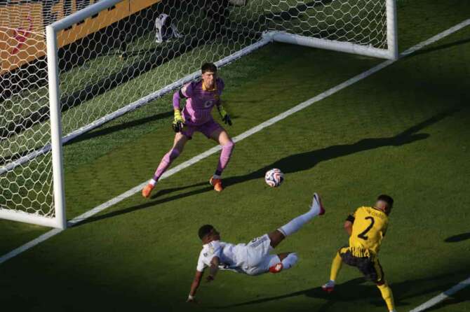 Real Madrid’s Kylian Mbappe, bottom, scores his side’s 3rd goal during the Club World Cup quarterfinal soccer match between Real Madrid and Borussia Dortmund in East Rutherford, N.J., Saturday, July 5, 2025. (AP Photo/Pamela Smith)